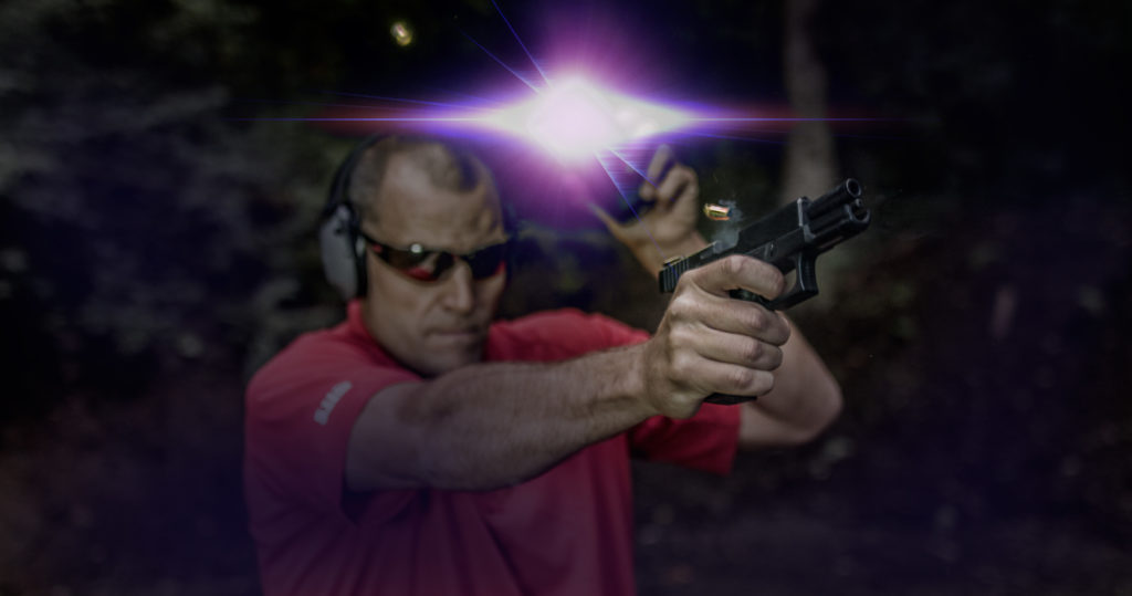 live fire at night with brass in the air shooting Glock 19